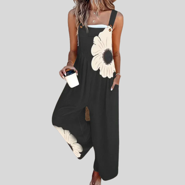 Schwarze Damen-Latzhose mit einer großen cremefarbenen Blüte